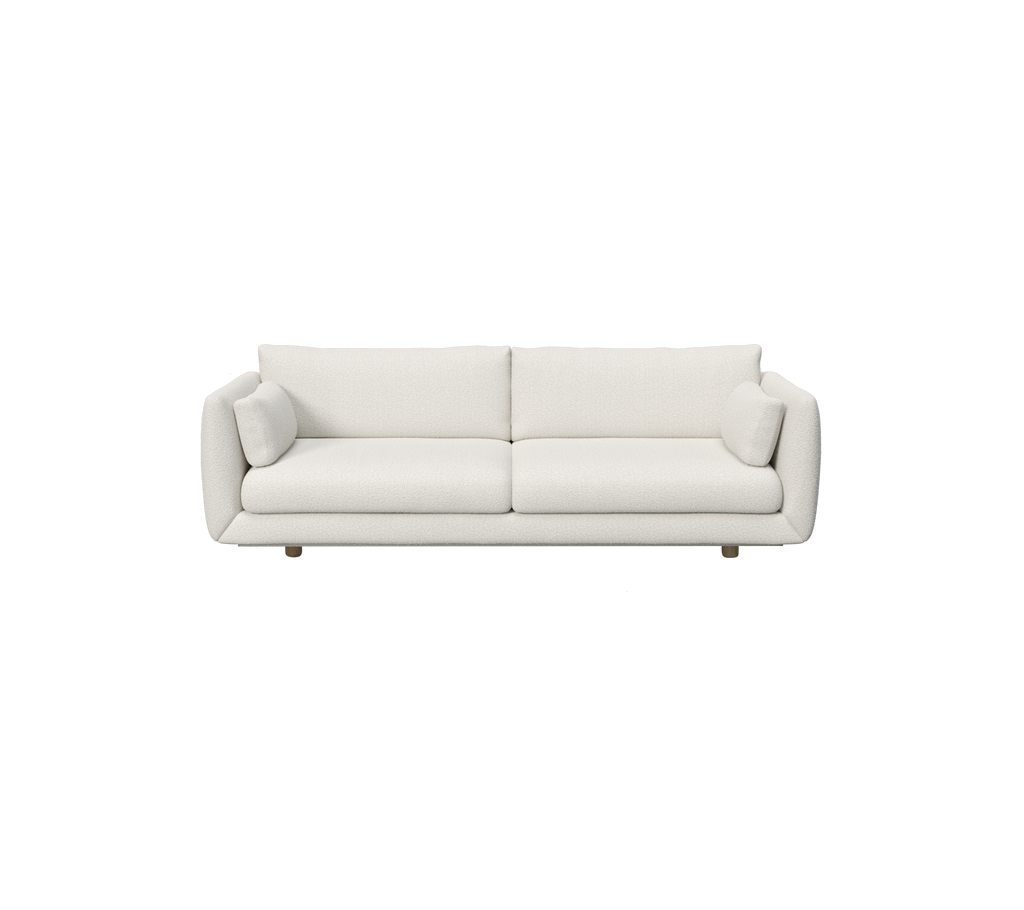 Modern white sofa with cylindrical cushions.