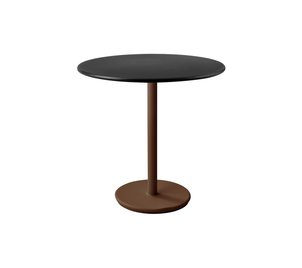 Modern black table with a desert red base in a lounge setting.
