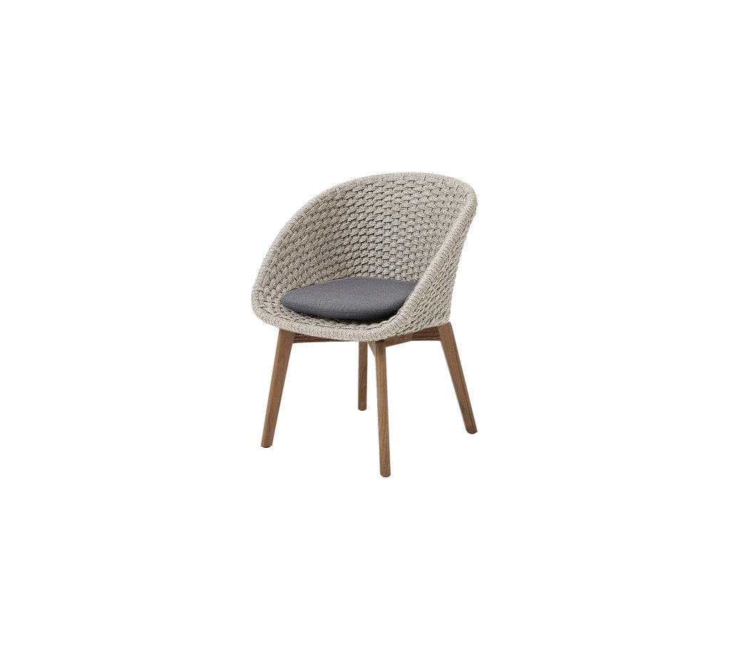Modern chair with sand-colored weave and grey cushion.