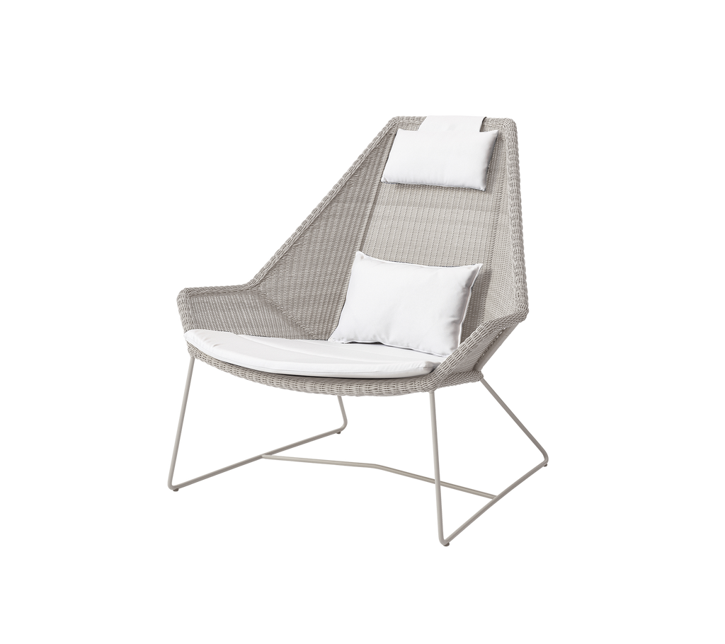 Modern chair with white cushions in a light, airy design.