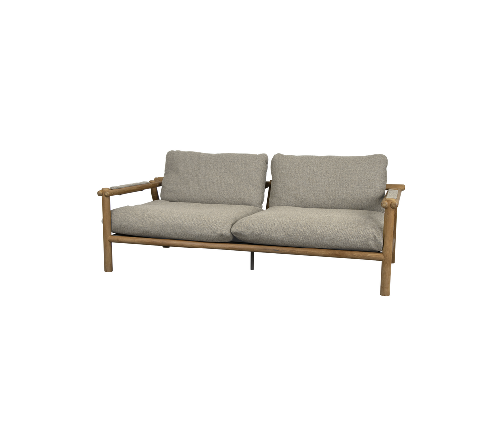 Modern teak sofa with light brown cushions in a lounge setting.