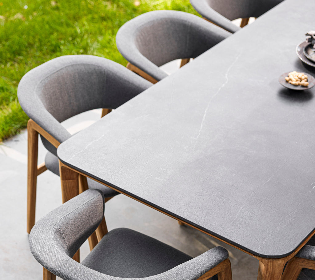 Stylish dining table with a smooth surface, surrounded by cozy Luna chairs featuring soft upholstery and wooden legs.