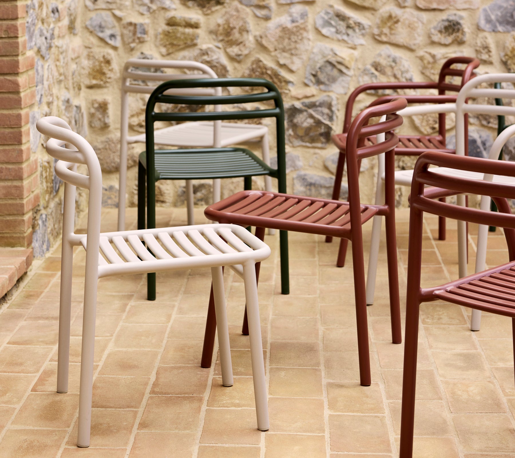 A collection of colorful Bliss chairs in various shades, showcasing a modern, minimalist design with slatted seats and curved backrests.