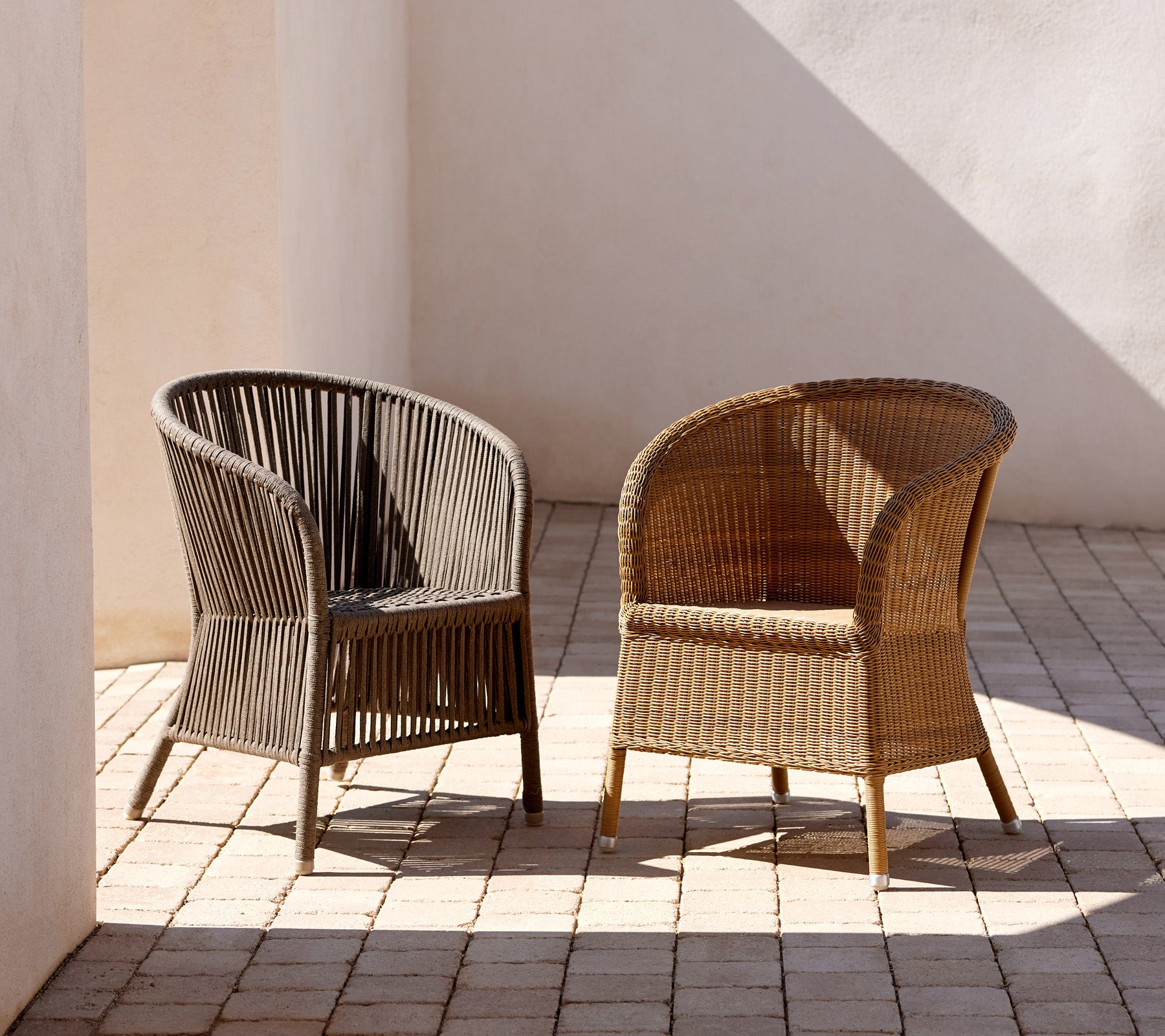 Two elegantly designed Derby chairs in contrasting colors, showcasing a stylish woven texture and a curved silhouette.