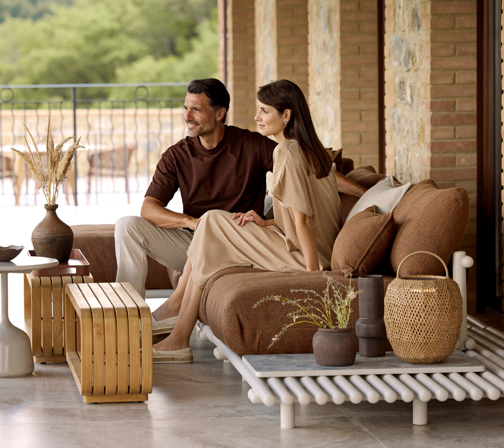 A stylish setting featuring a glow lamp on a unique platform, complemented by a mellow coffee table and cozy seating arrangements.