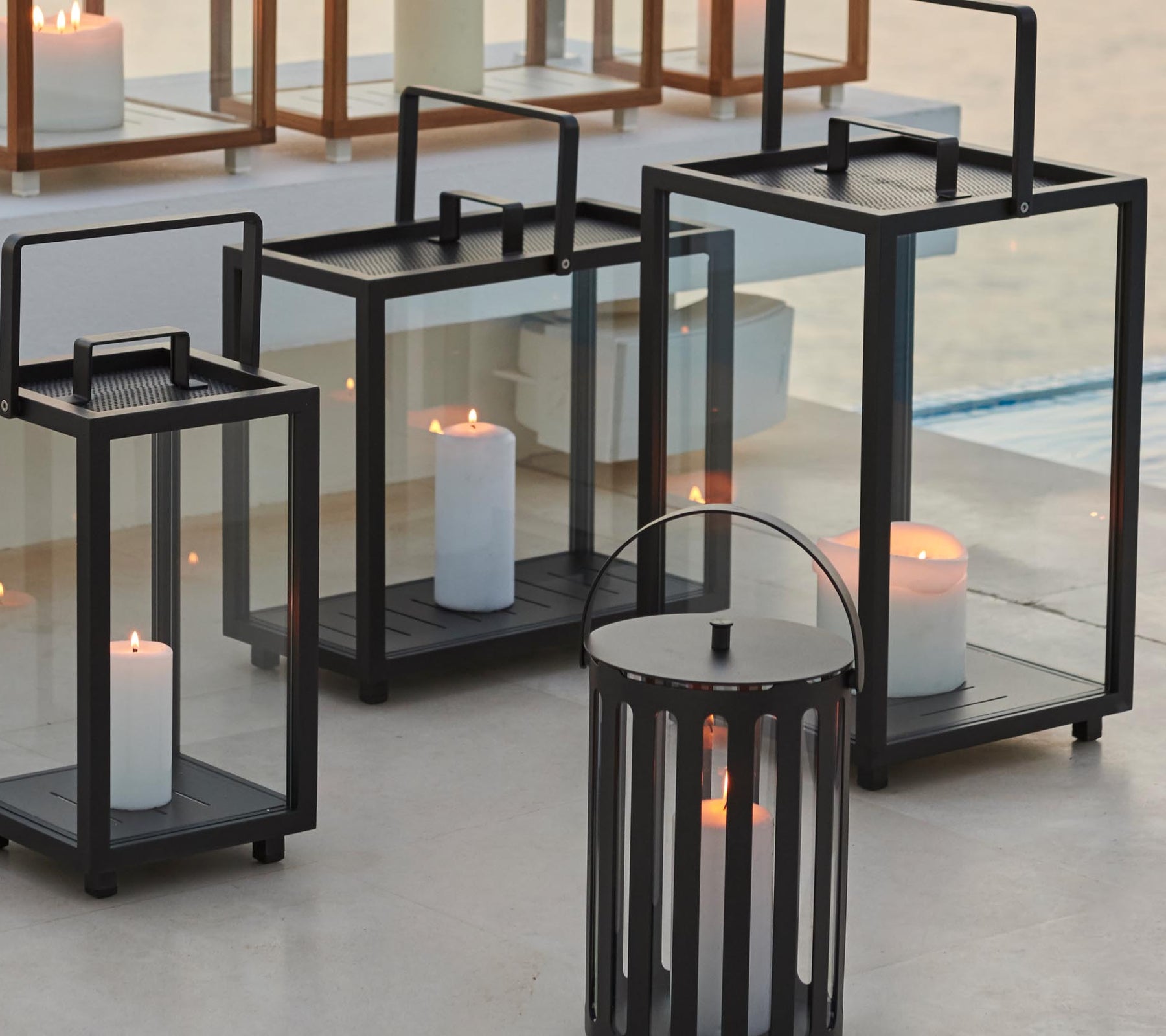 Decorative lanterns in various sizes with candles inside, creating an inviting ambiance.