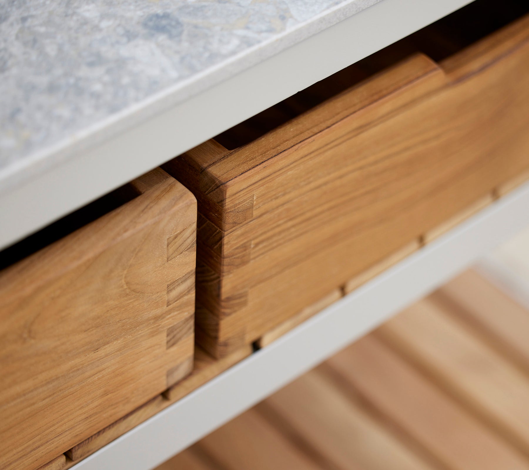 Teak boxes with a smooth finish, neatly stored and organized, showcasing craftsmanship and natural wood grain.
