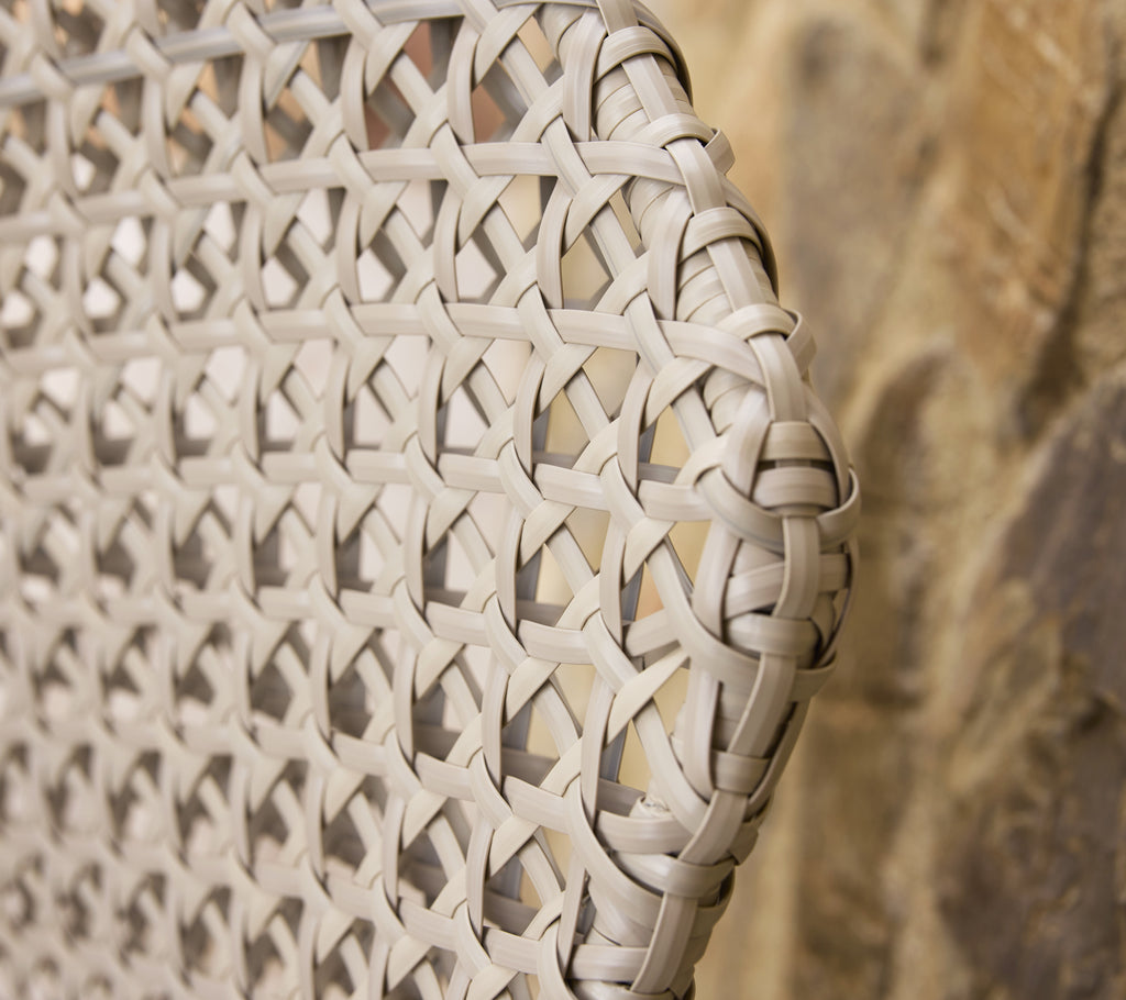Close-up of a textured dark sand vibe weave, showcasing the intricate patterns and craftsmanship of the material.