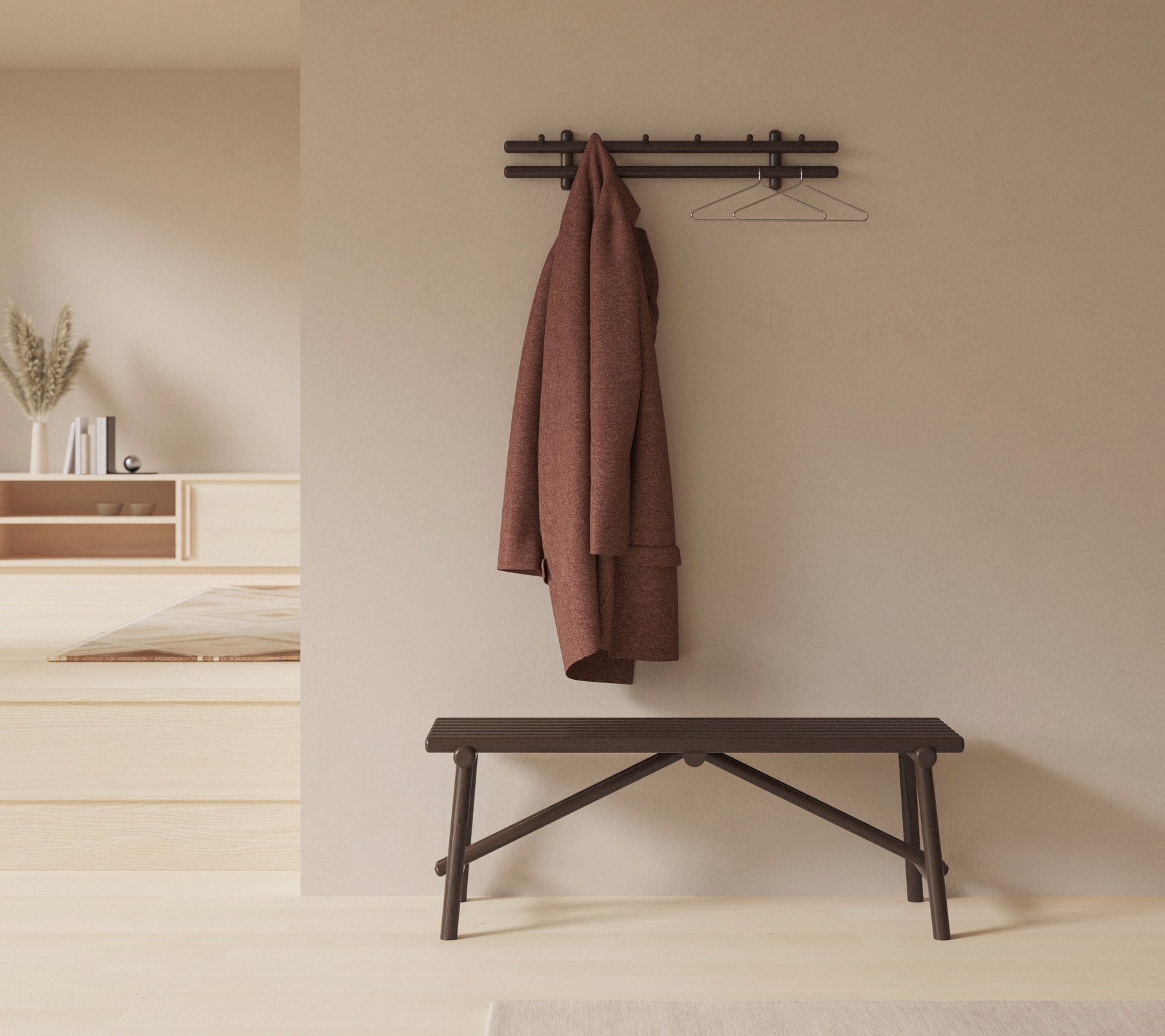 A minimalist setting featuring a wooden bench and a coat hanging on a wall-mounted rack, enhancing the space's simplicity and functionality.